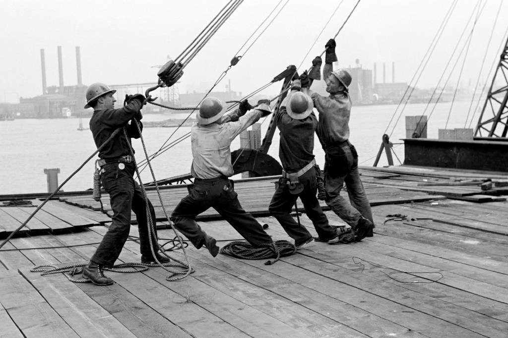 Steel workers hoist a girder in place in the meeting hall area of the UN Headquarters where construction was completed in June 1951.